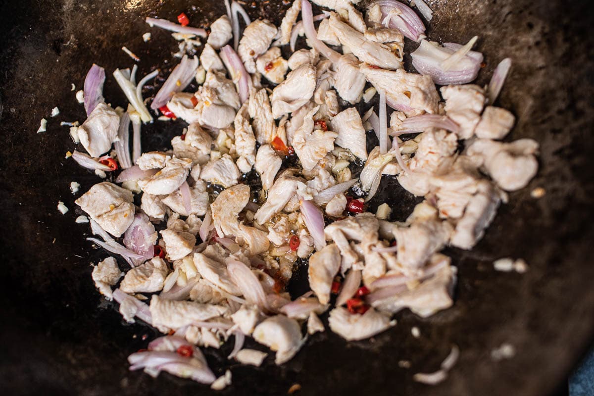 garlic, chilis, shallot and chicken in a wok