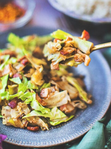 fork picking up stir fried cabbage