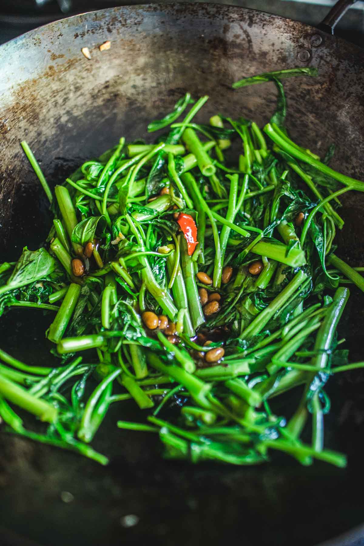 morning glory stir fried in a wok with soy bean paste