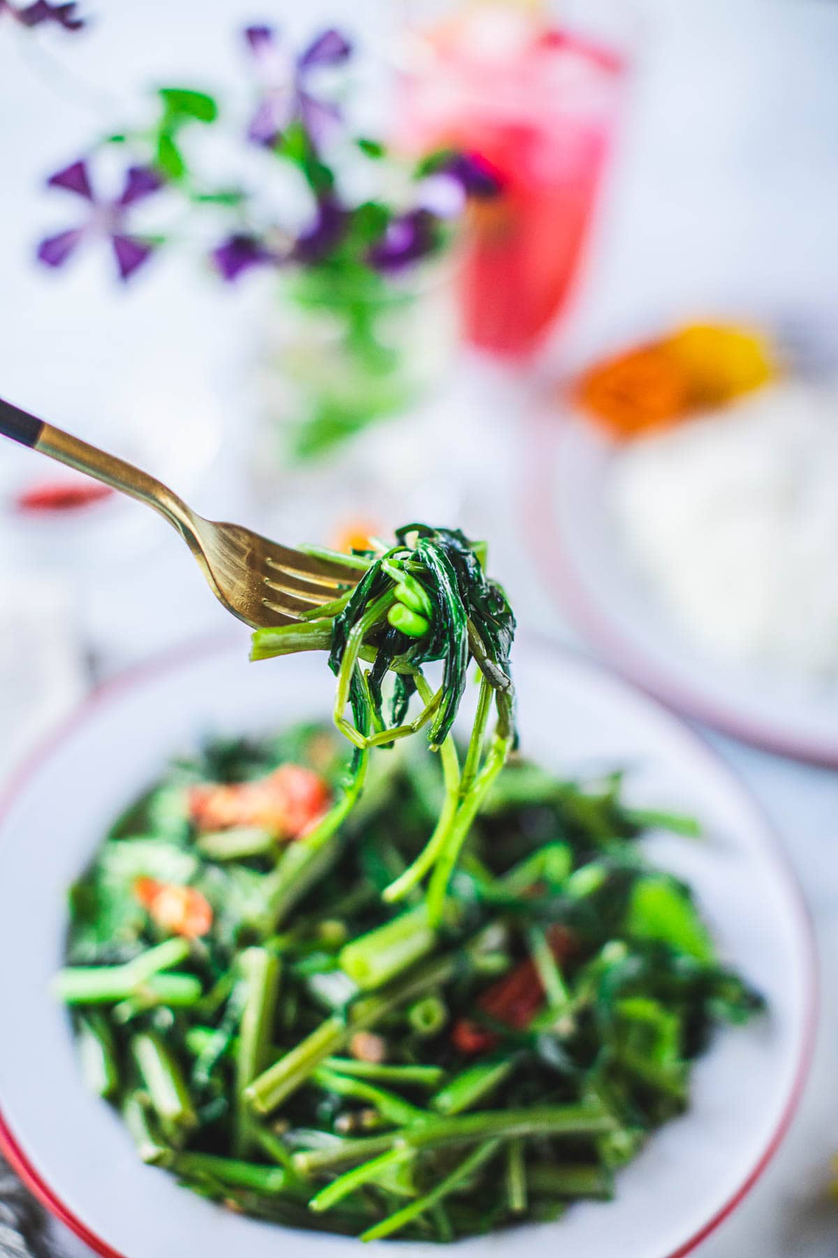 pad pak boong stir fry lifted on a fork