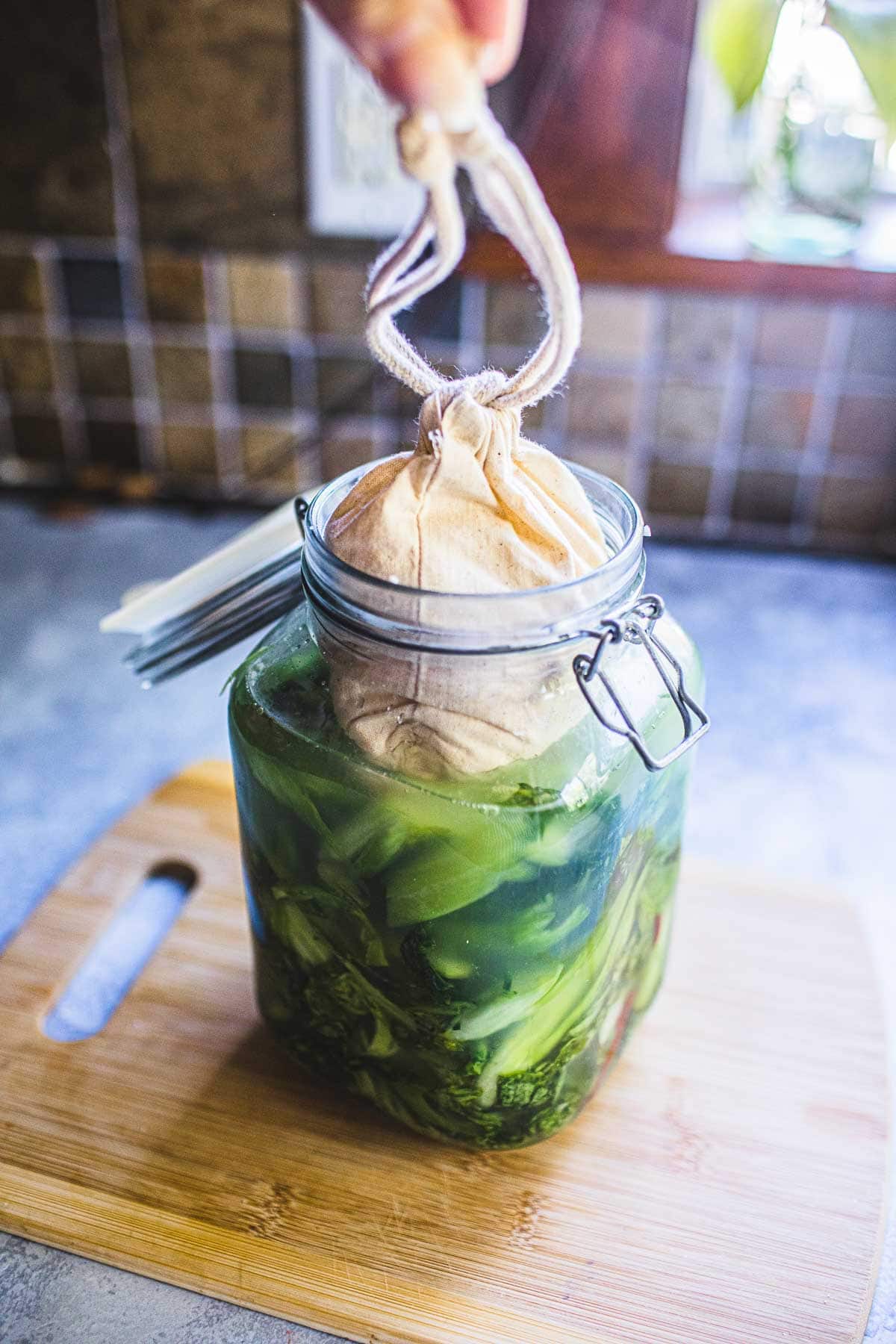 cotton cloth on top of mustard green jar