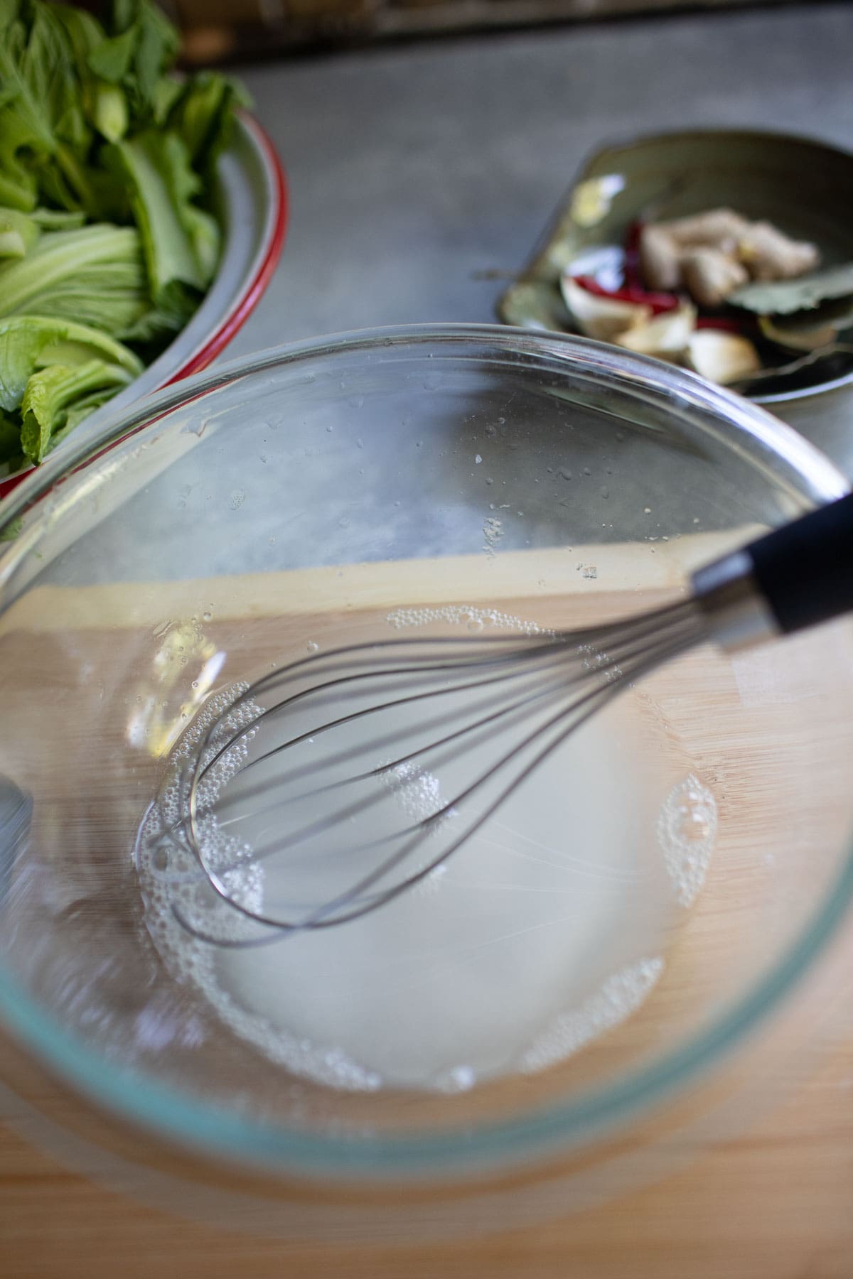 whisking salt and vinegar in a glass bowl