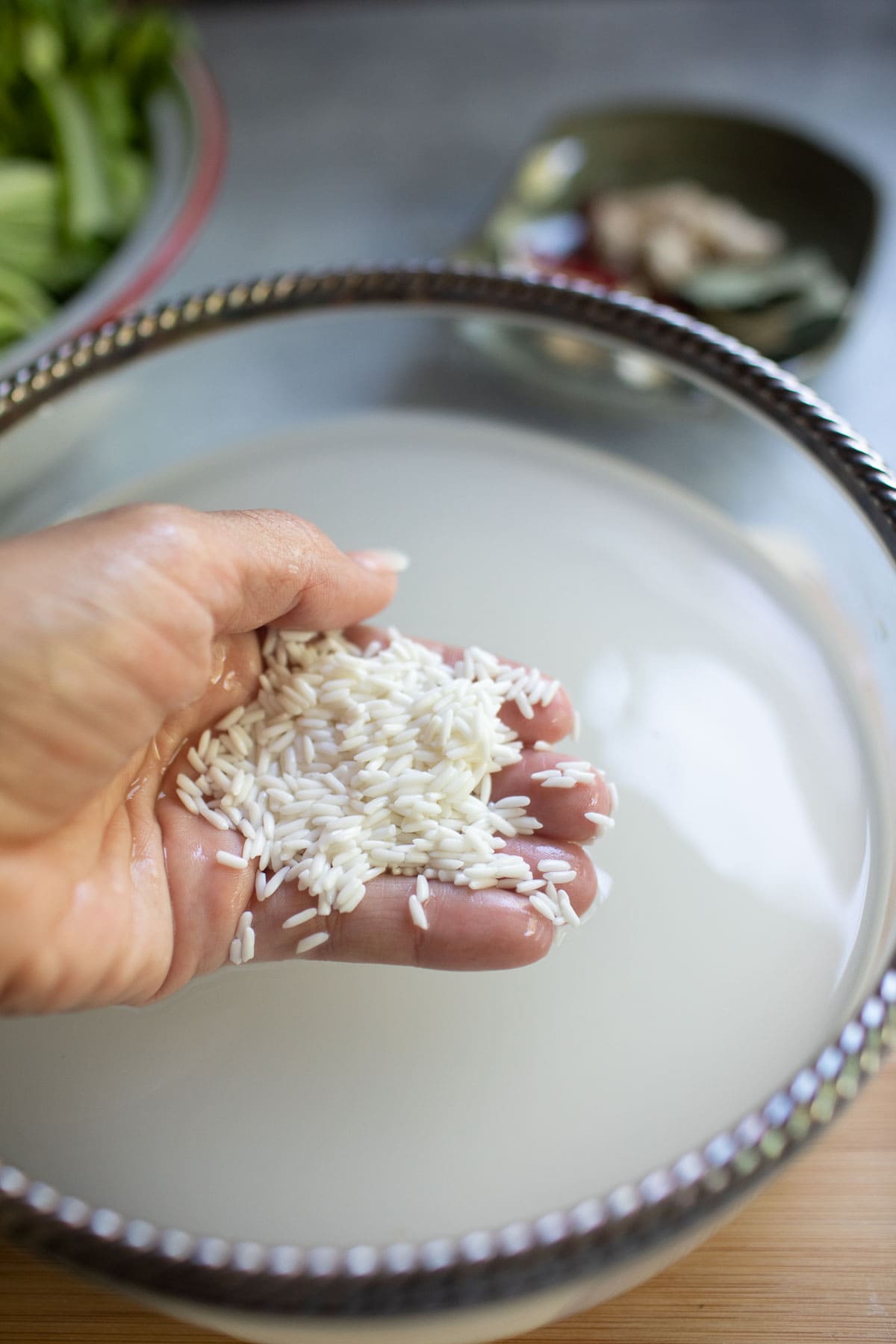 hand holding Sticky rice grains in water