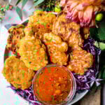 Thai corn fritters with dipping sauce on a cutting board