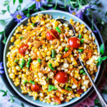 corn salad on a table with flowers