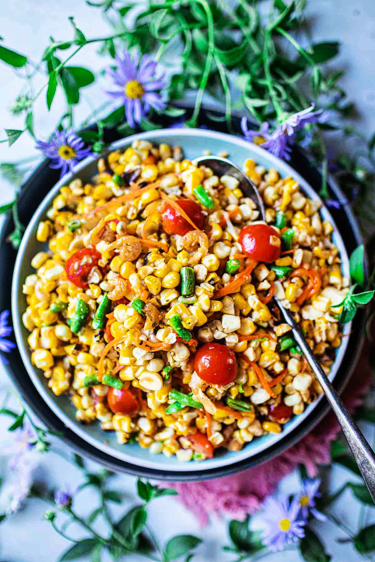 thai spicy corn salad i a bowl with spoon in the middle