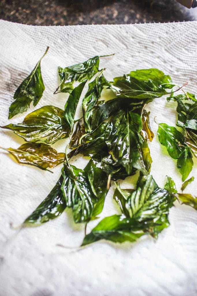 fried basil over lined paper towel