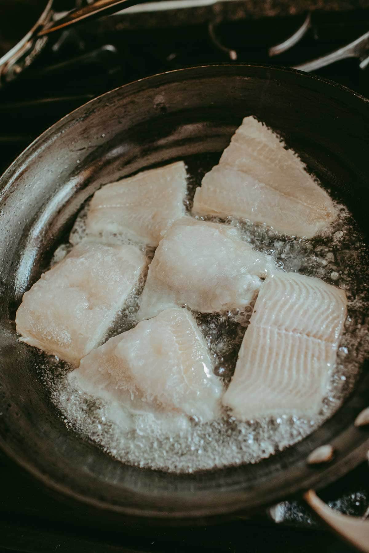 Catfish fillets frying in a pan