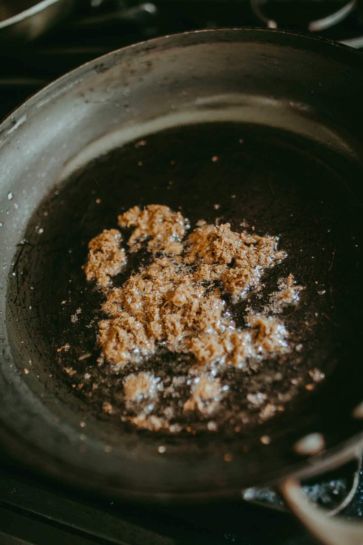 frying red curry in pan with oil