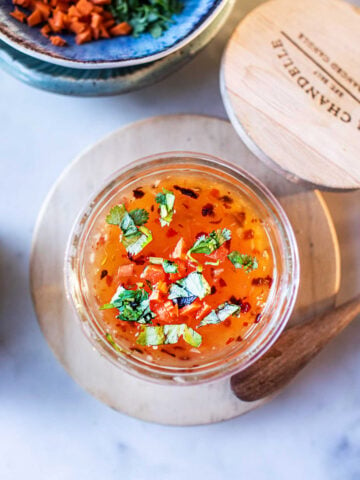 Thai sweet chili dipping sauce in a glass bowl on table