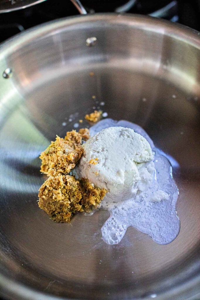 choo chee curry paste with coconut milk in a pan