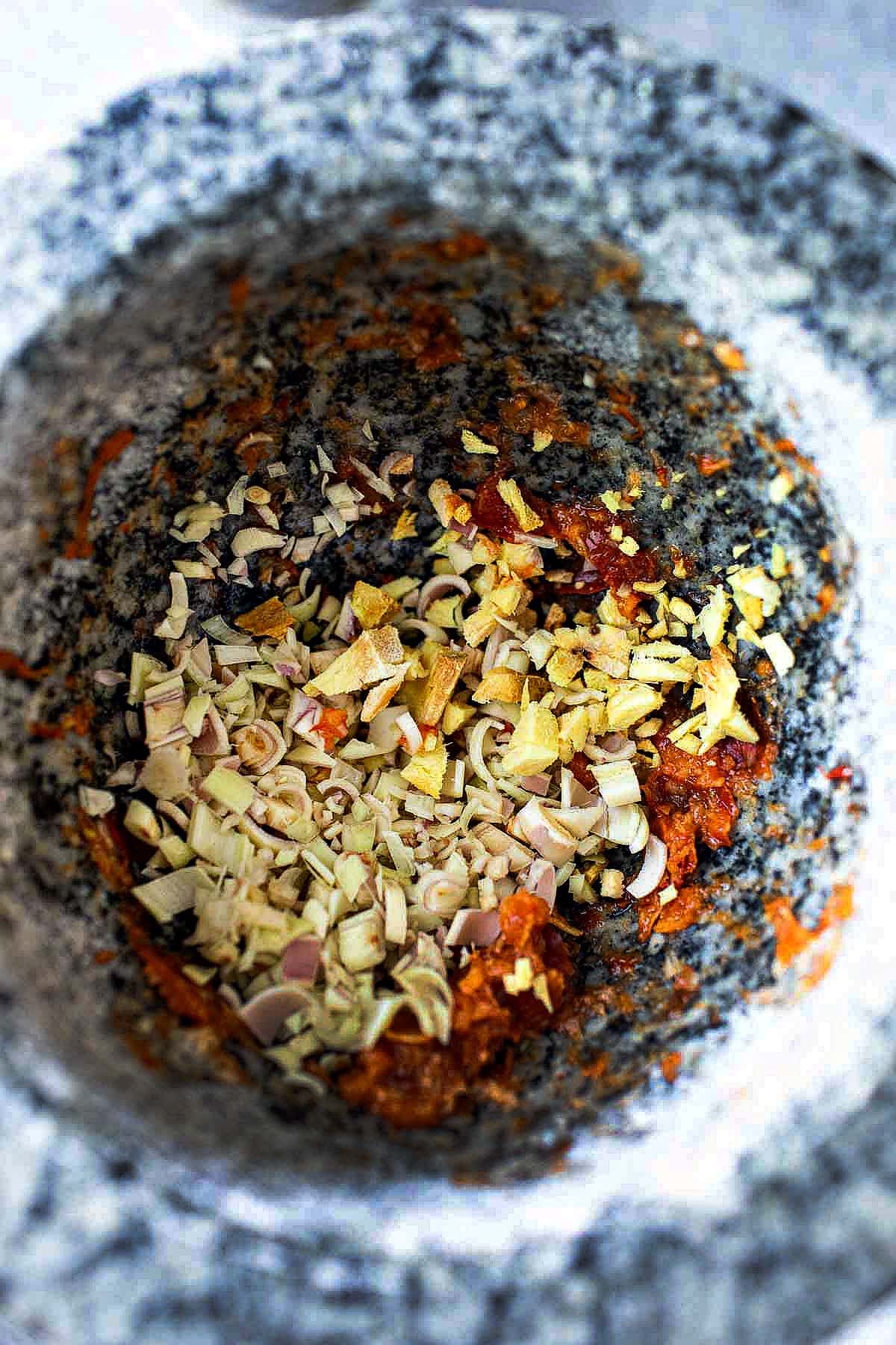 lemongrass in stone mortar for making curry paste