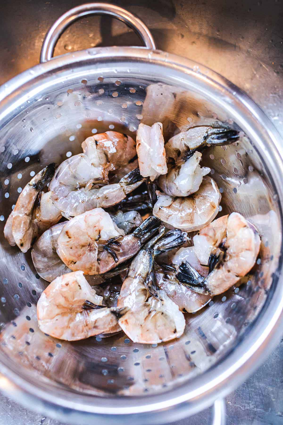 shrimp with shells in colander for tom yum soup