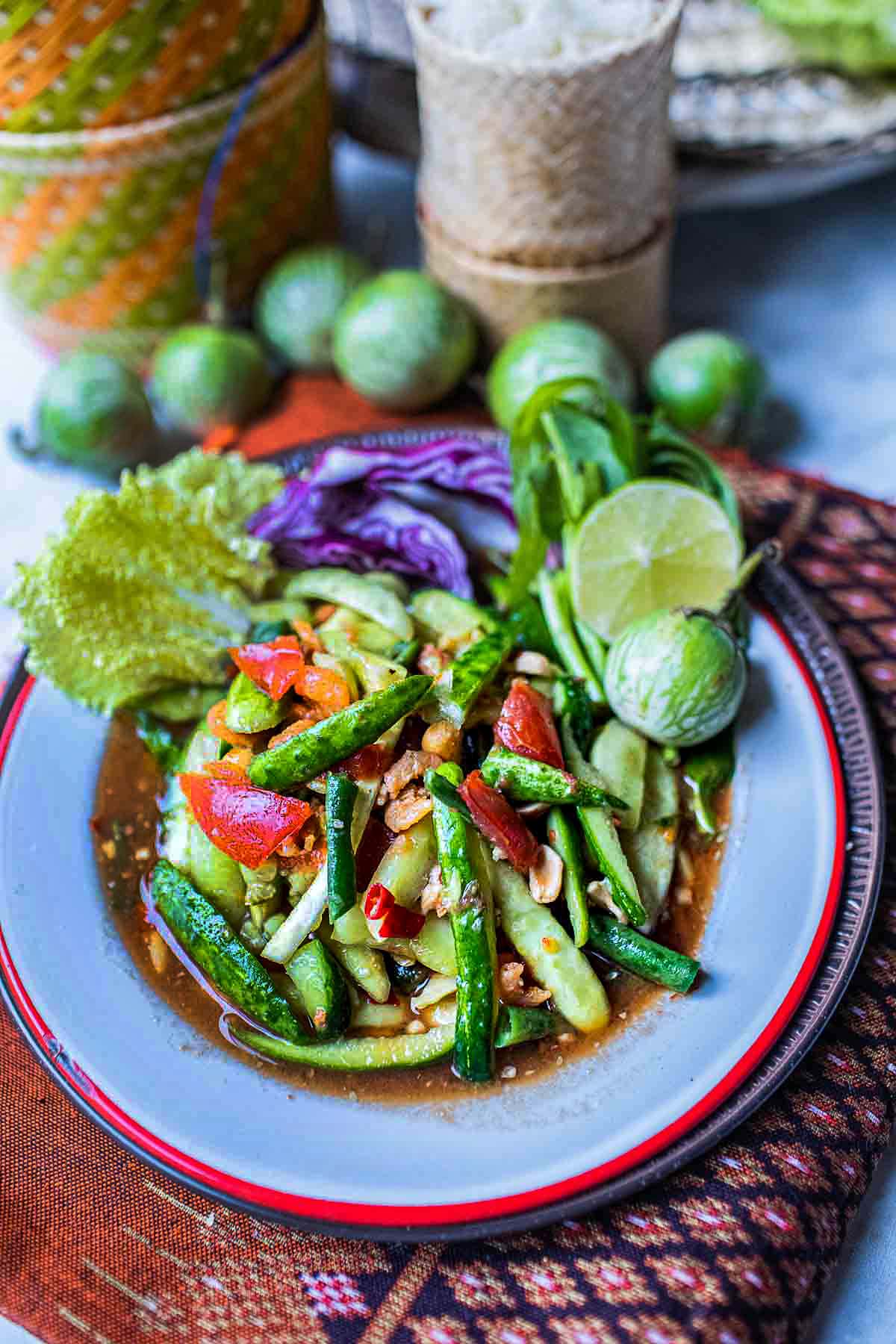 lao spicy cucumber salad in a plate with garnishing vegetables