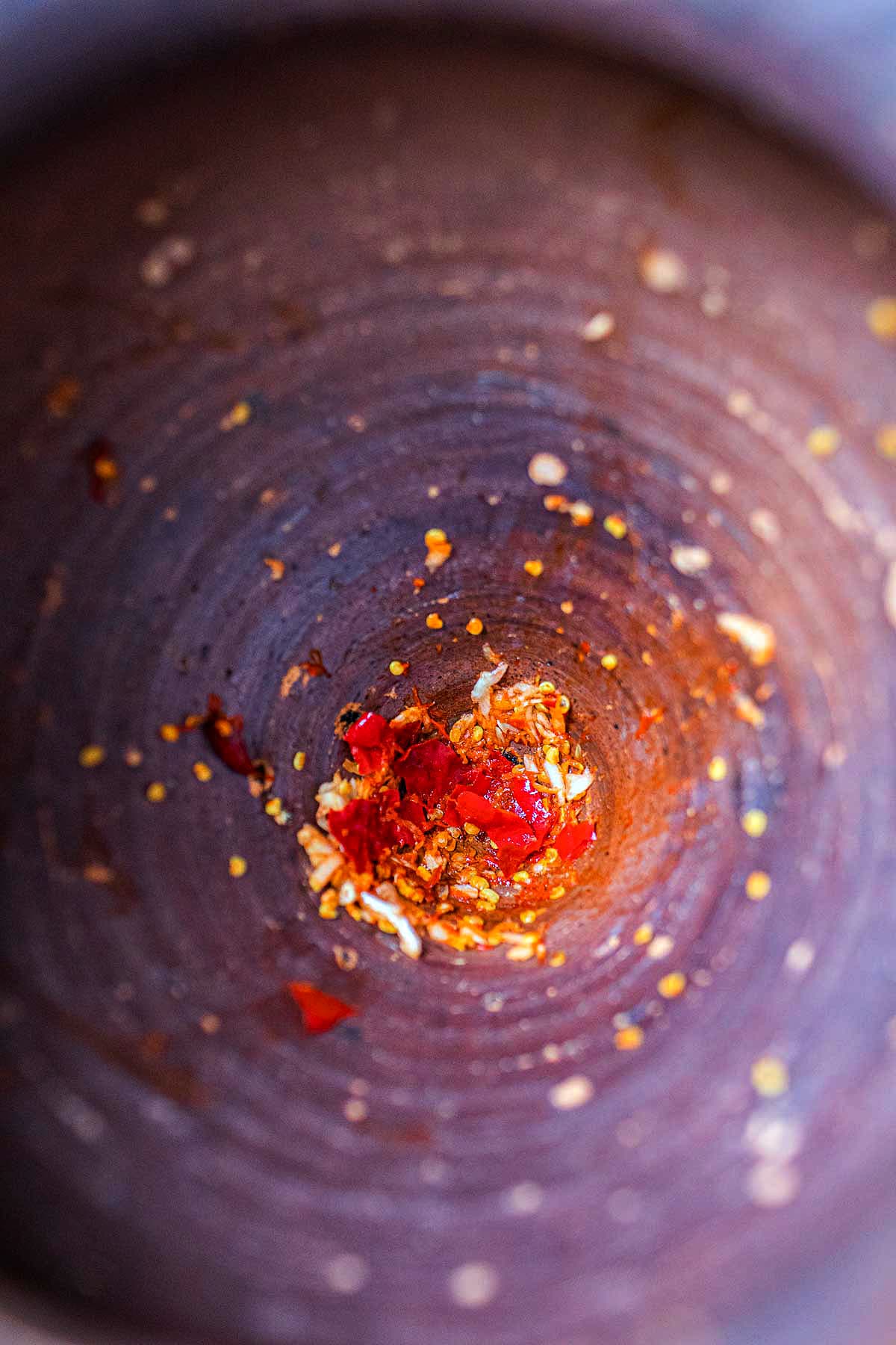 chilis and garlic pounded in a mortar