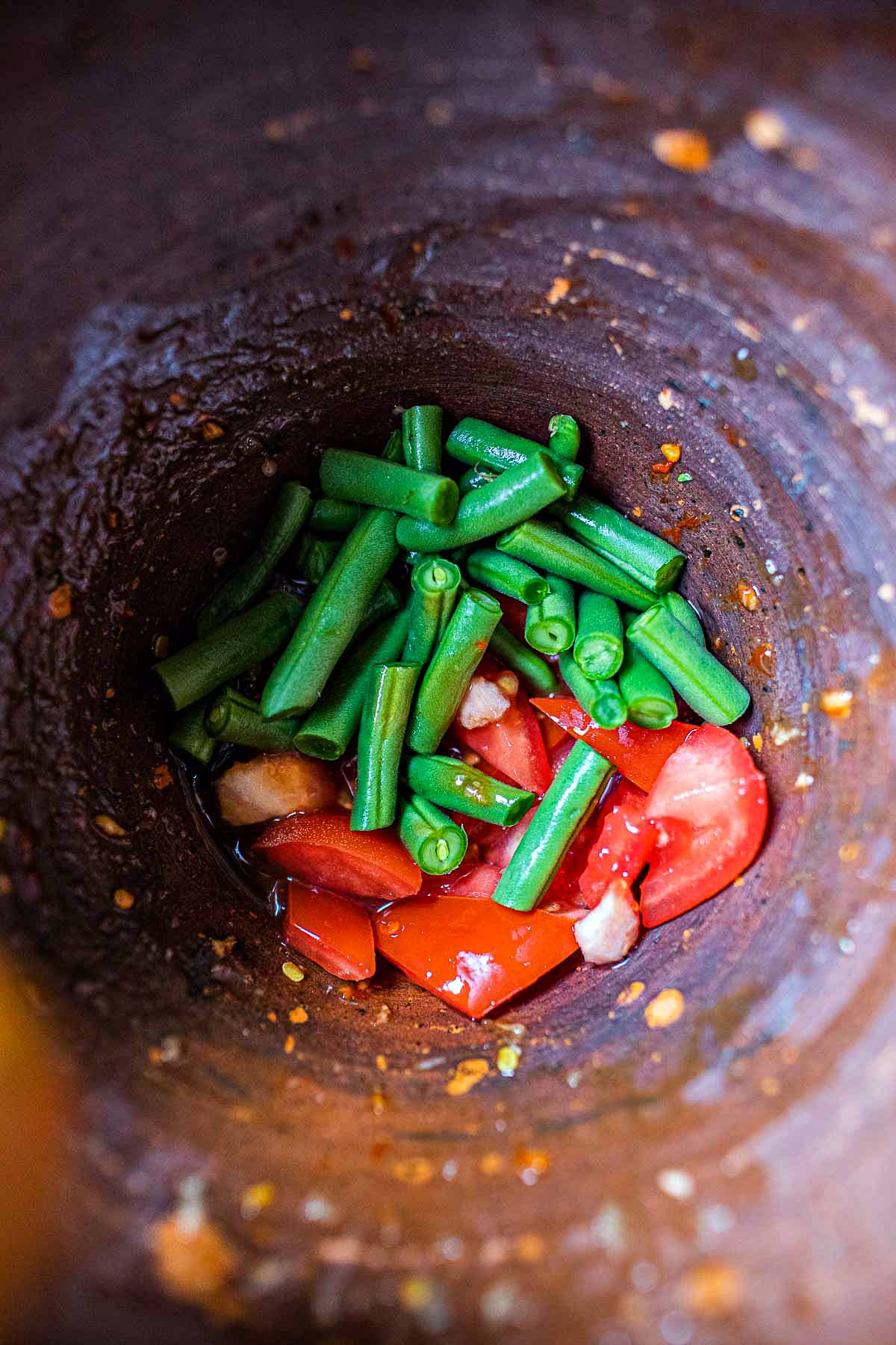 beans and tomatoes in mortar
