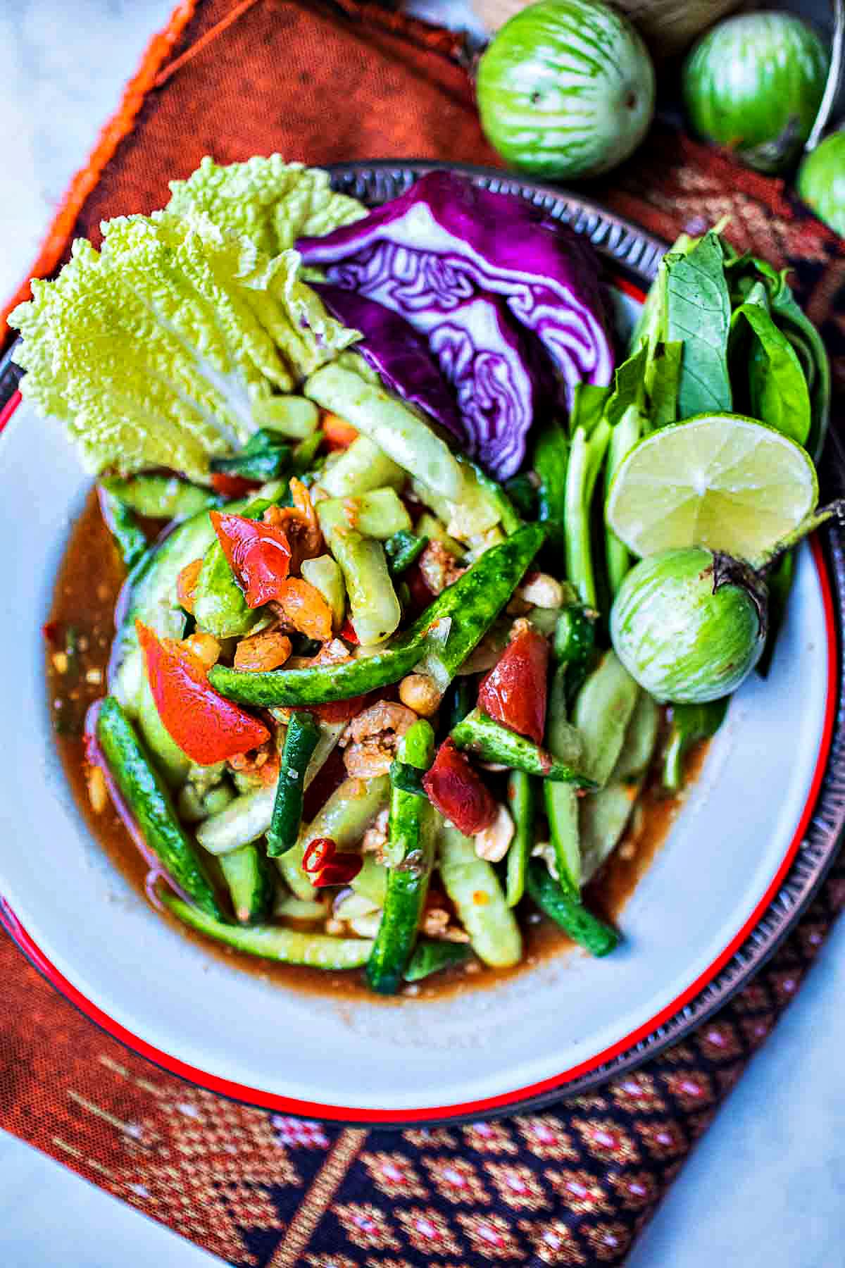 spicy cucumber salad recipe in a plate with vegetables garnish