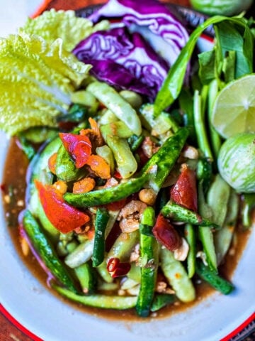 lao cucumber salad in a white plate