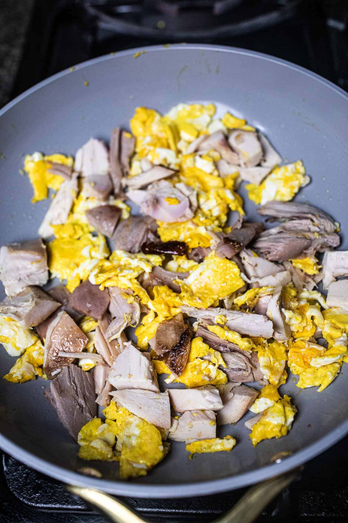 egg and turkey stir fried in a pan