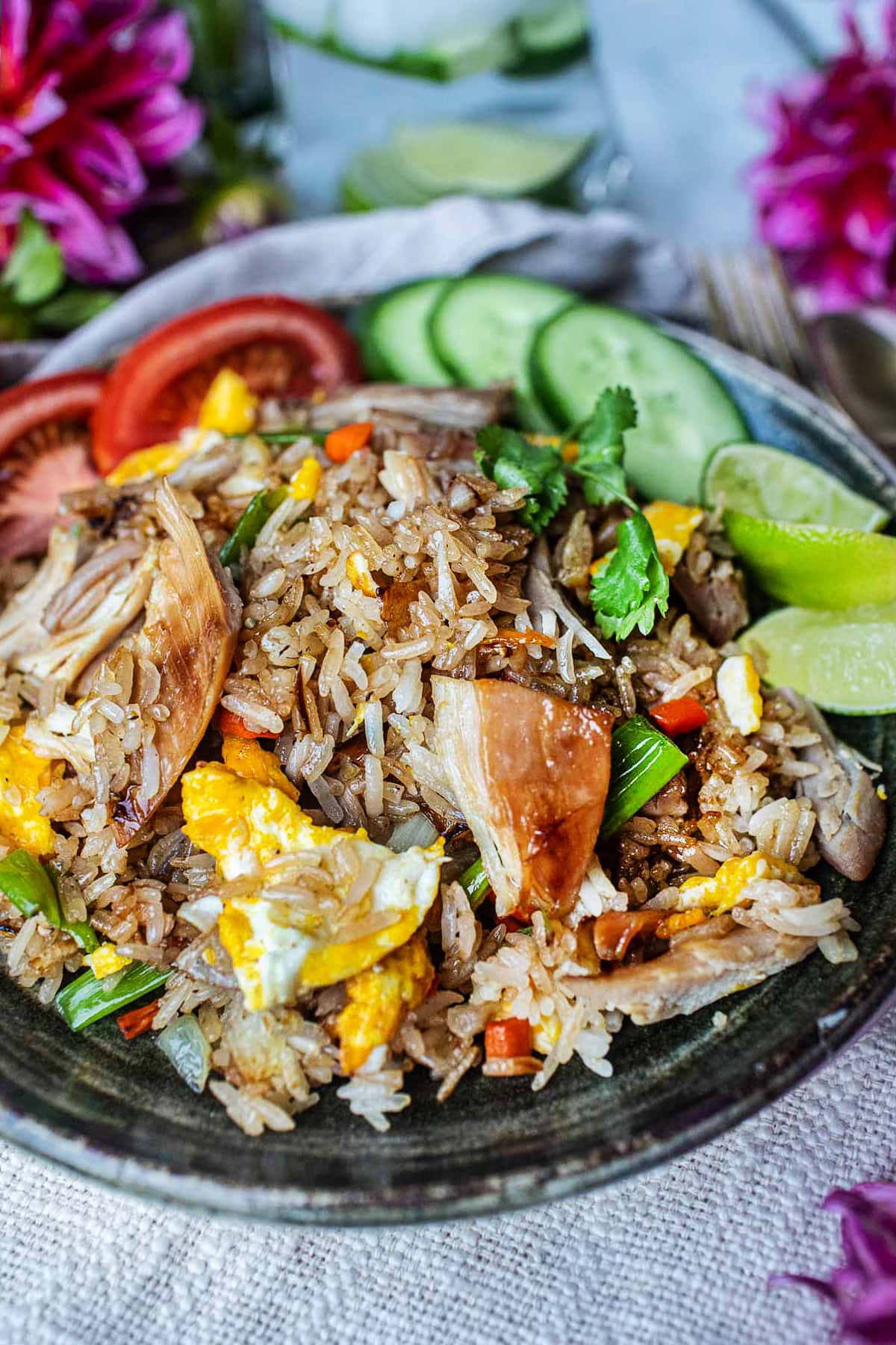 thai fried rice with turkey meat ona plate with cucumbers