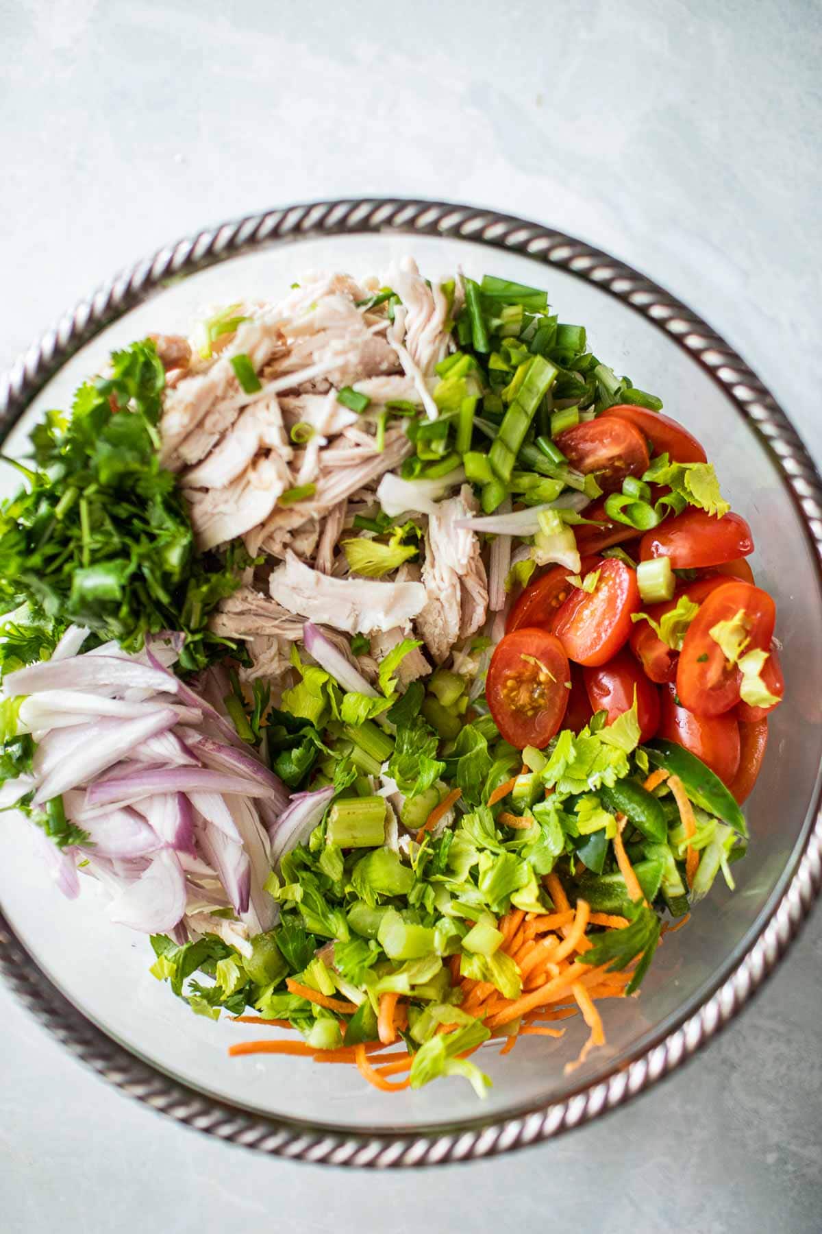 veggies, turkey and herbs in a glass bowl