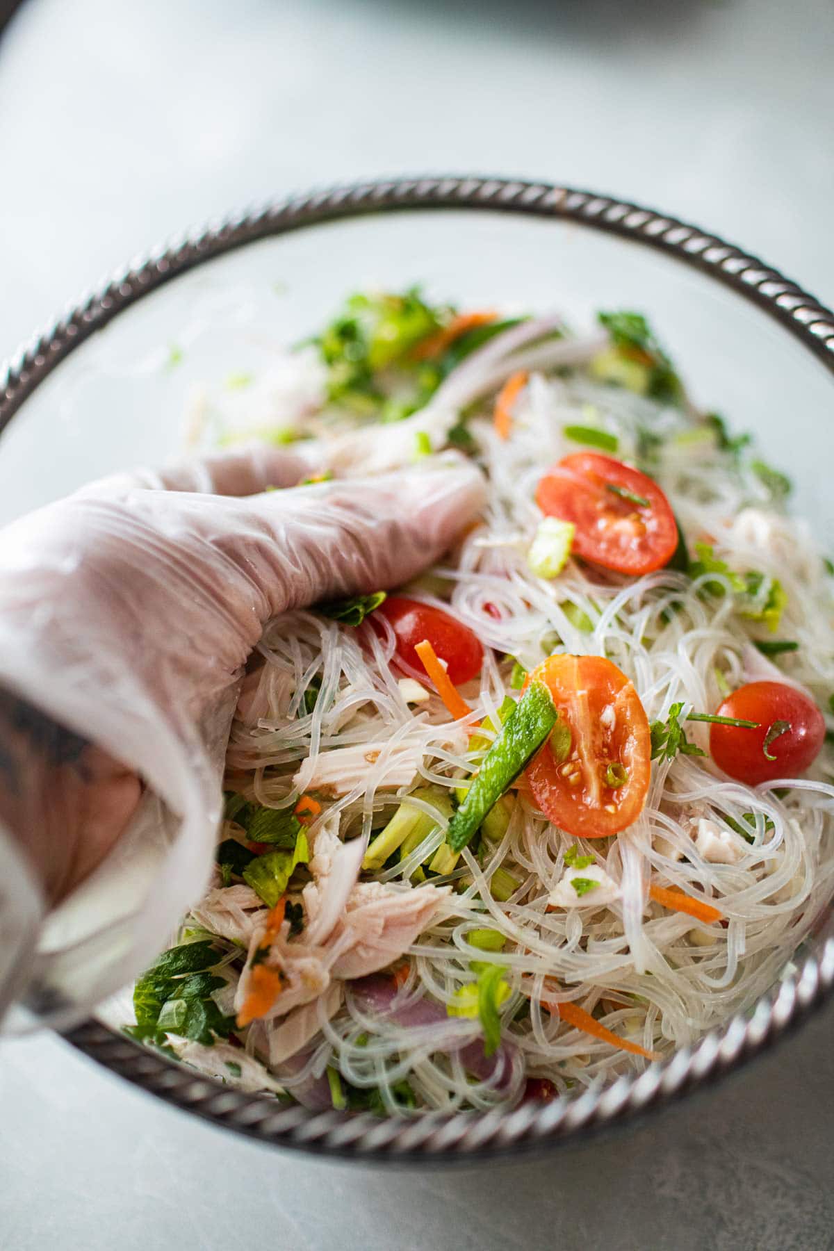 hand in glove massaging glass noodles salad