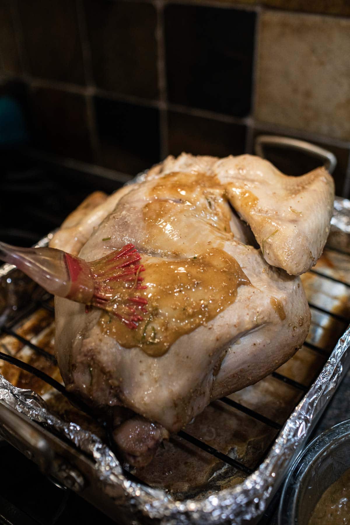 brushing marinating sauce on turkey