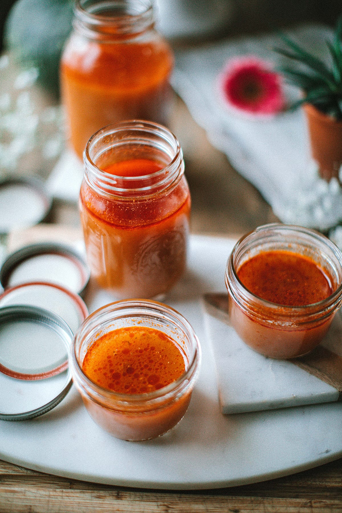 tom yum broth in glass jars on table