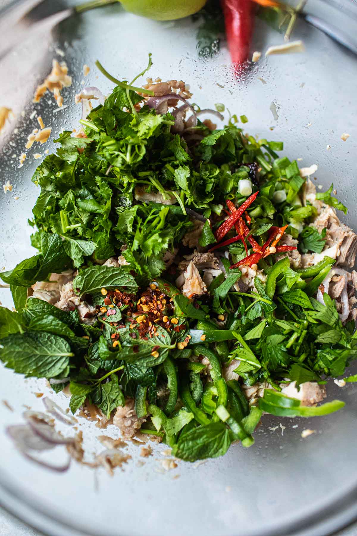 fresh herbs mixed in a bowl for larb recipe