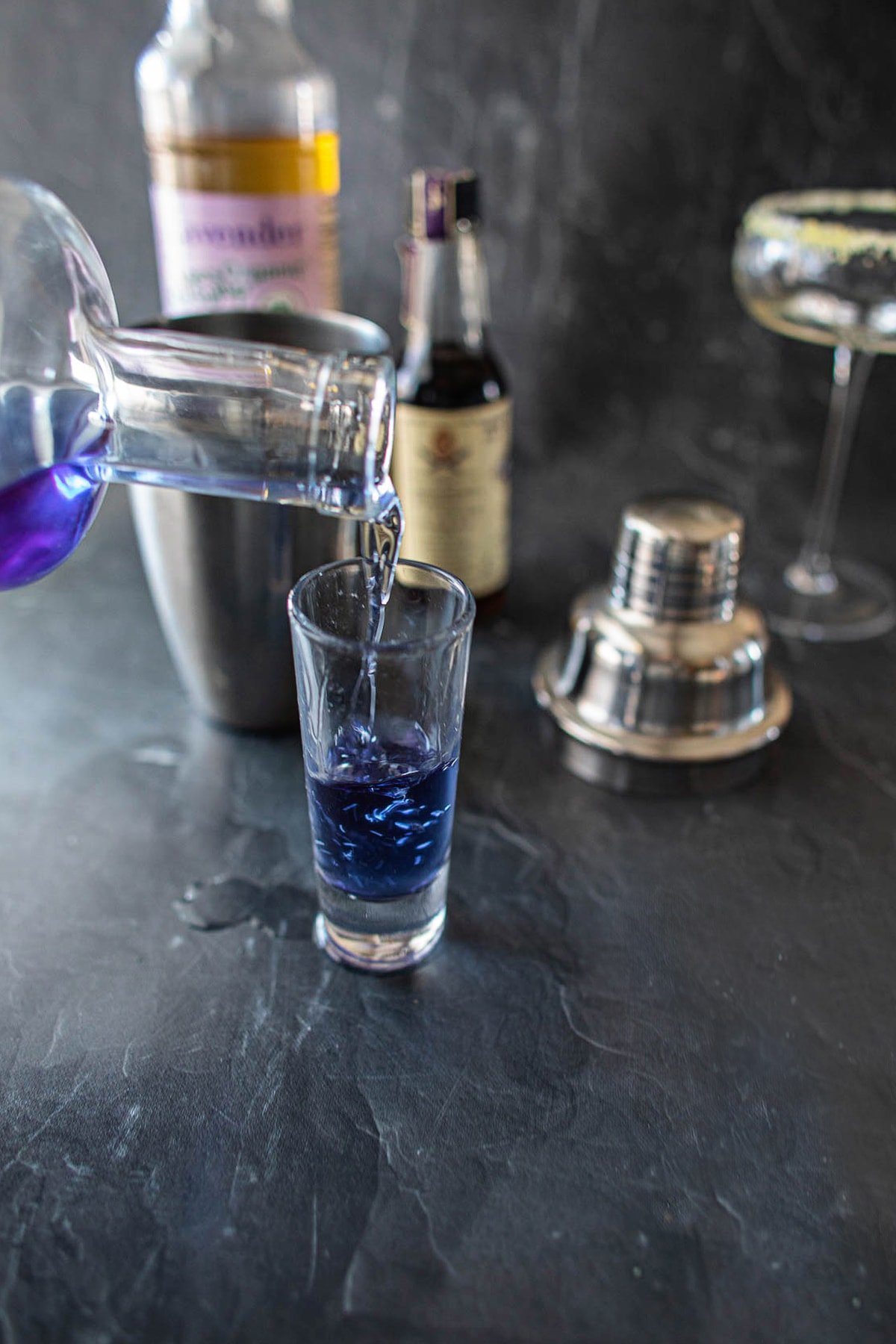 Empress gin pouring onto a shot glass