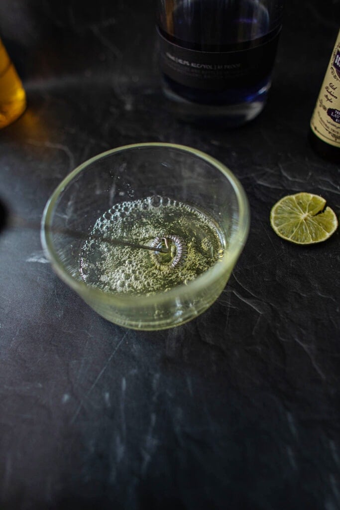 frothing egg white in a glass bowl