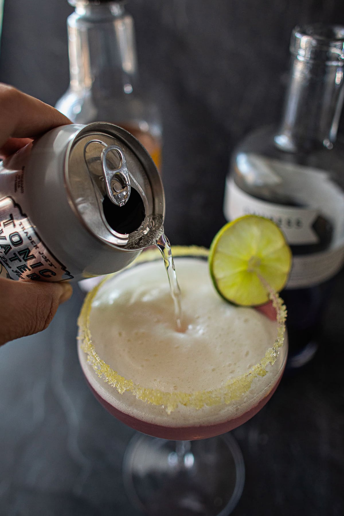 tonic pouring into empress gin cocktail