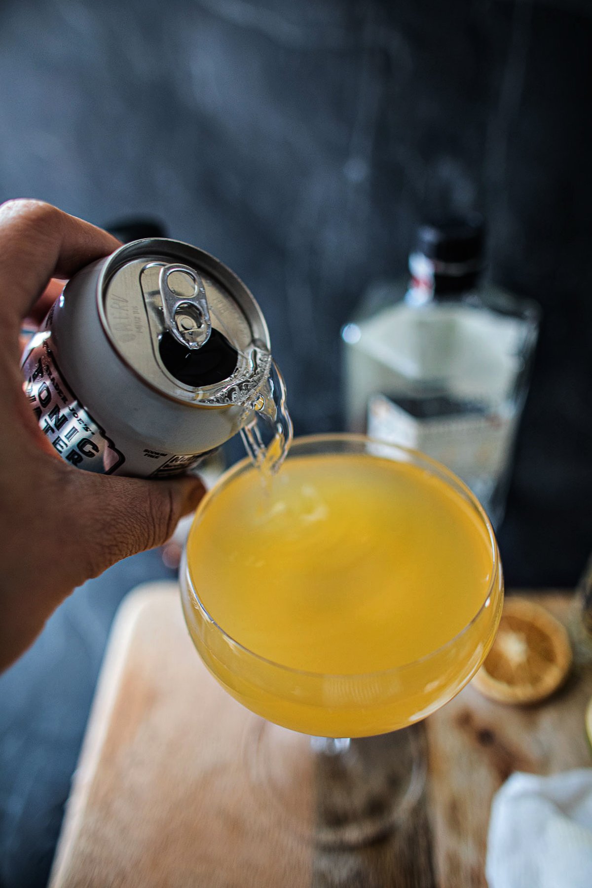 tonic water pouring into Roku gin cocktail