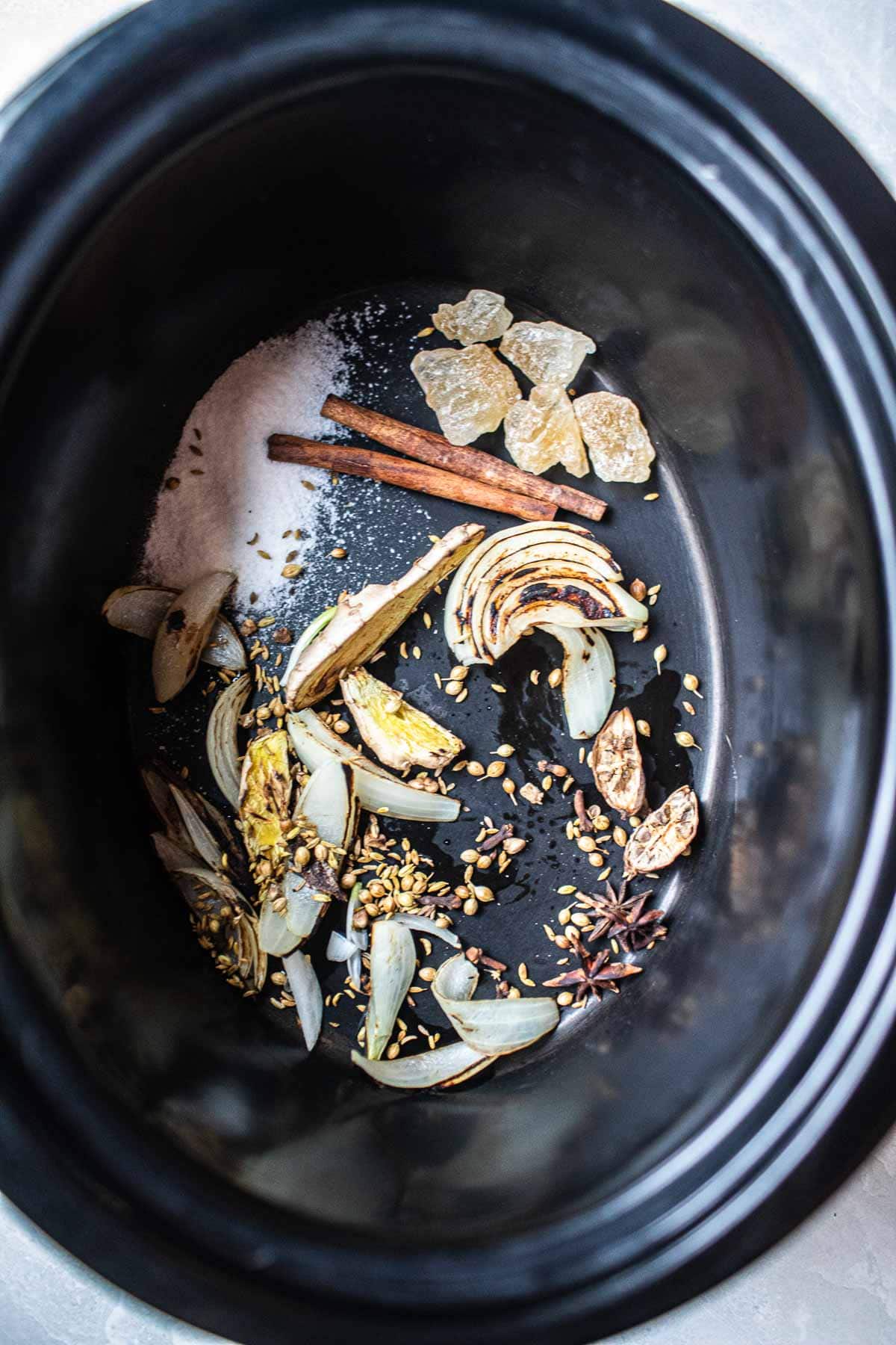 pho spices and herbs in a slow cooker 