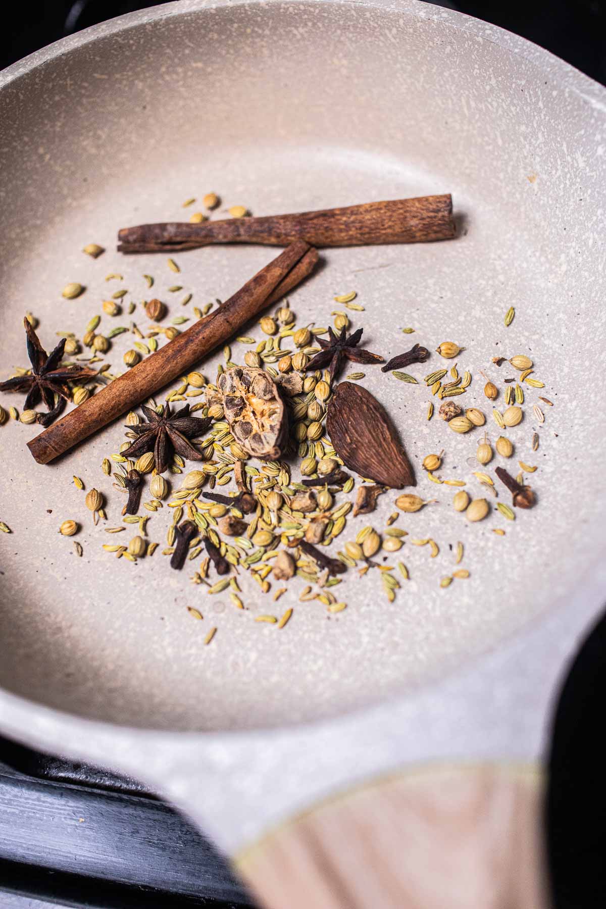 toasted dry spices for making pho in a pan