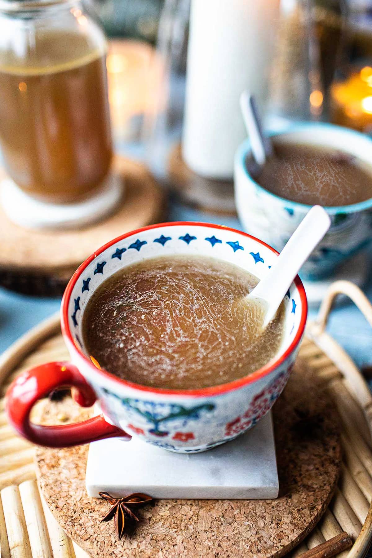 turkey pho broth in a mug with a spoon dipped in