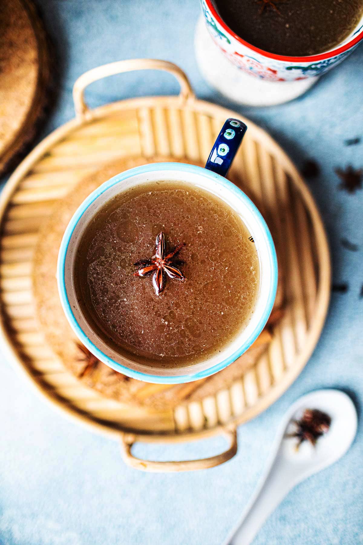 turkey bone pho broth in a cup with star anise