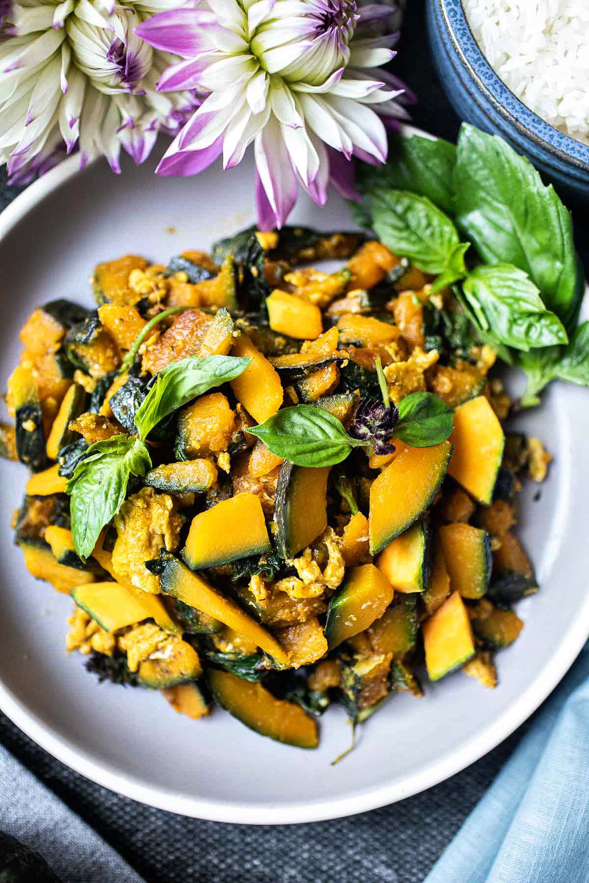 Thai kabocha squash stir fry on a gray plate