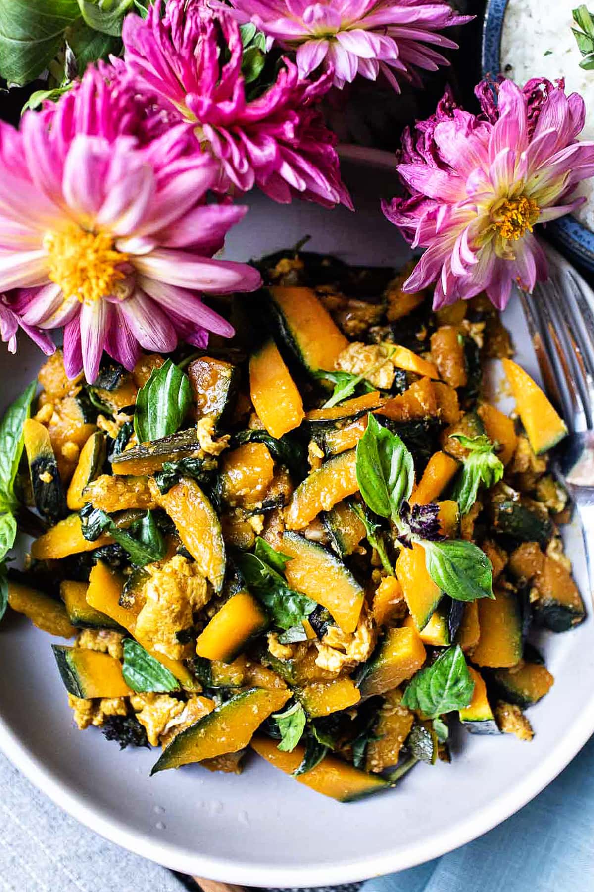 kabocha stir fry in a plate with pink flowers