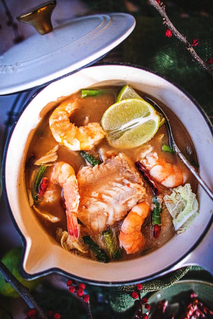 Sour soup in a white stock pot.
