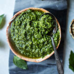 thai basil pesto in a bowl with a spoon on the side