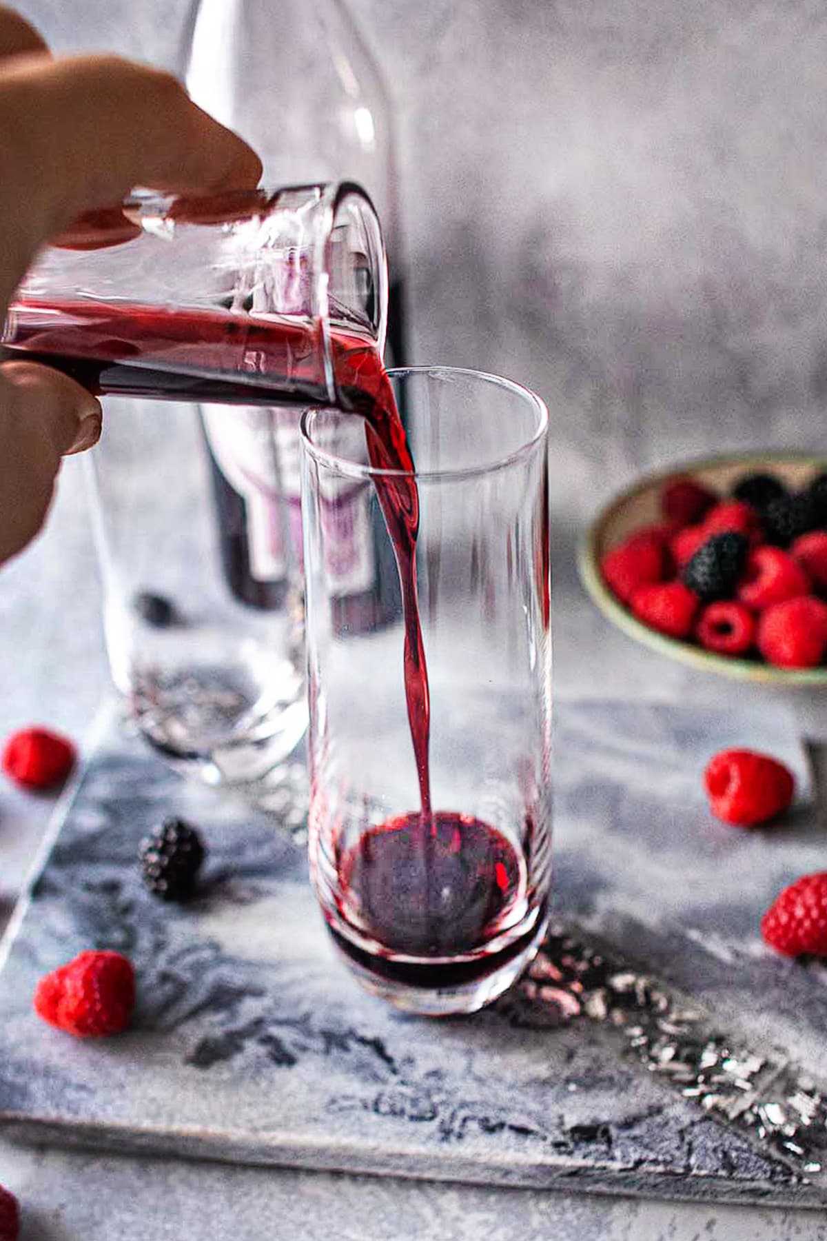 Creme de cassis pouring into a champagne glass