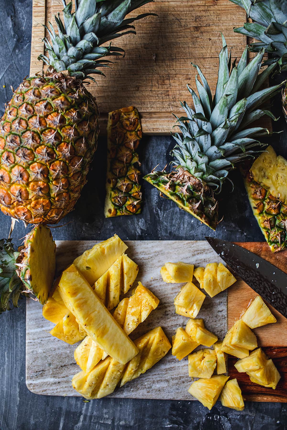 Sliced pineapple on a cutting board.