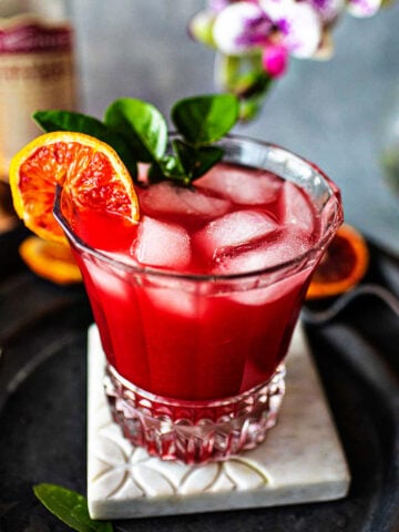 Tanqueray Sevilla orange blossom drink on a tray on the table.