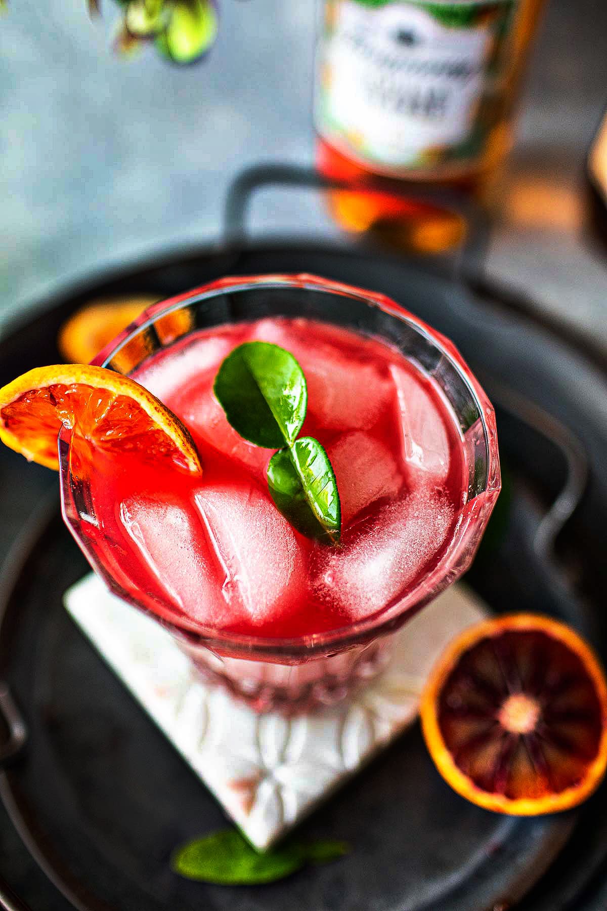 Tanqueray Sevilla cocktail with kaffir leaves garnish.
