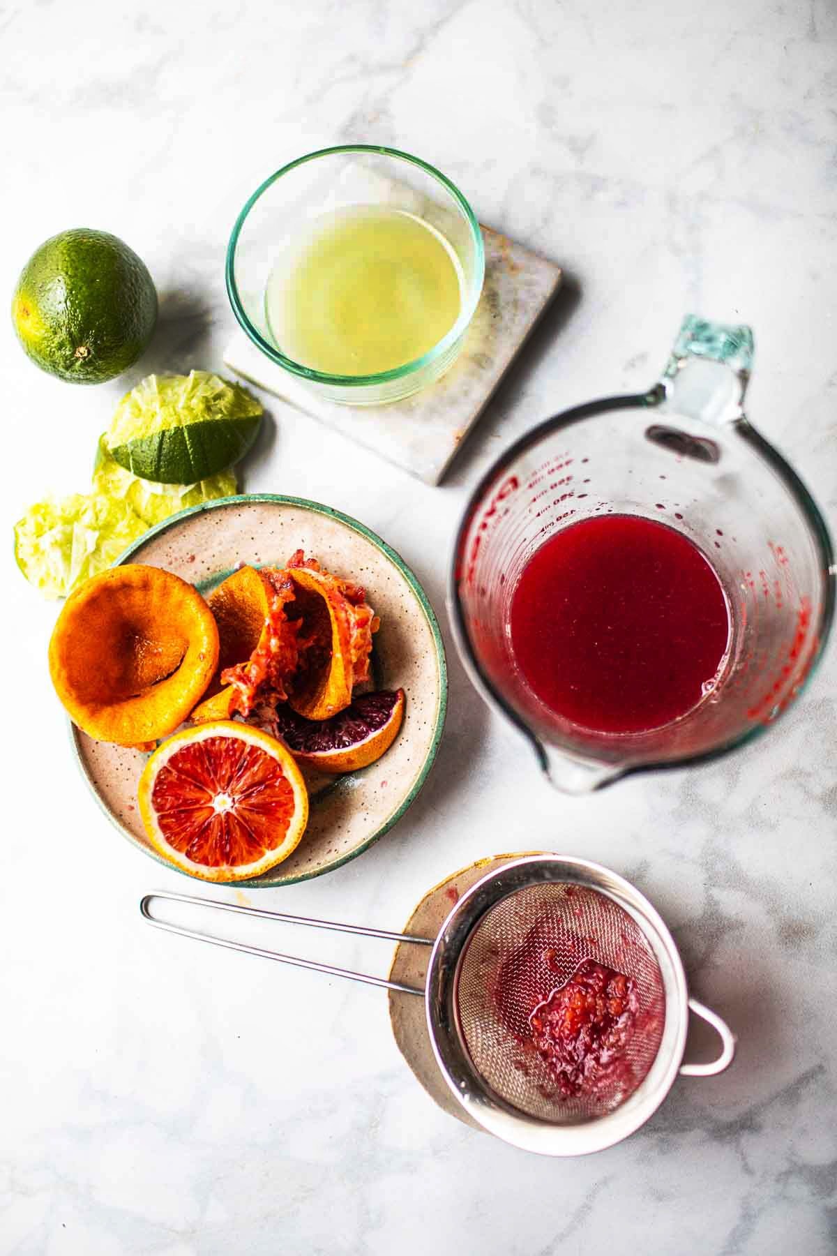 Fresh squeezed Blood orange and lime juice on a table. 