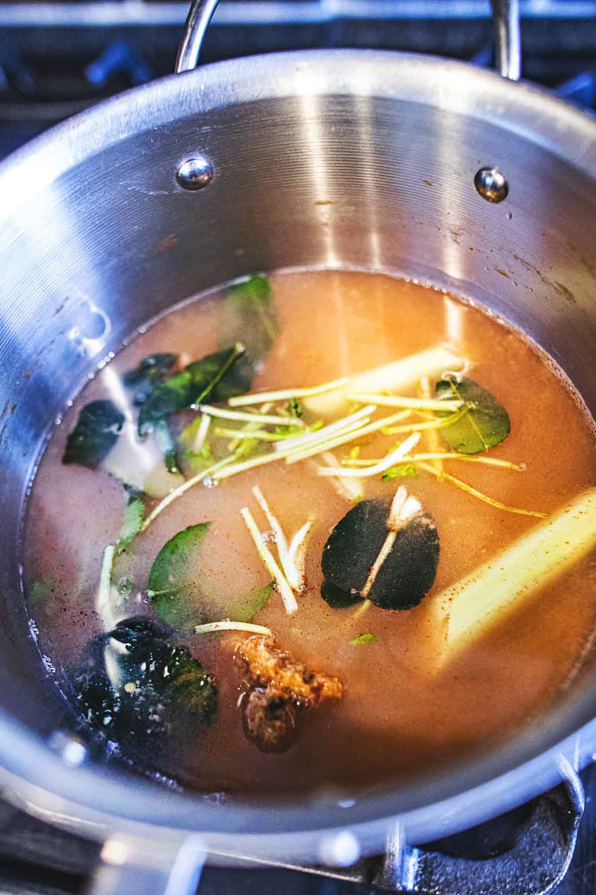 aromatics added to a pot of Tom Yum broth.