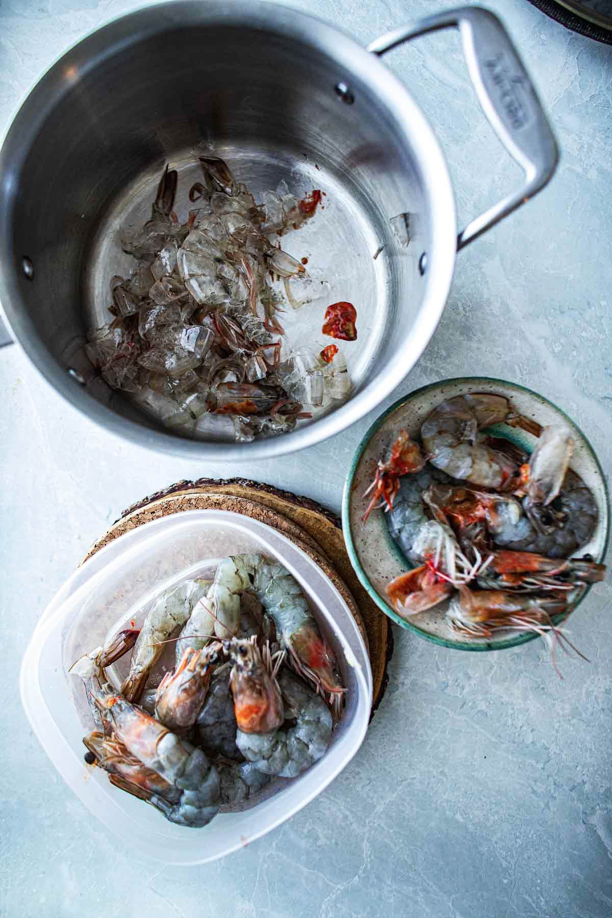 Large prawns heads and shells removed on a table.