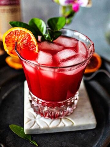 Tanqueray Sevilla orange blossom drink on a tray on the table.
