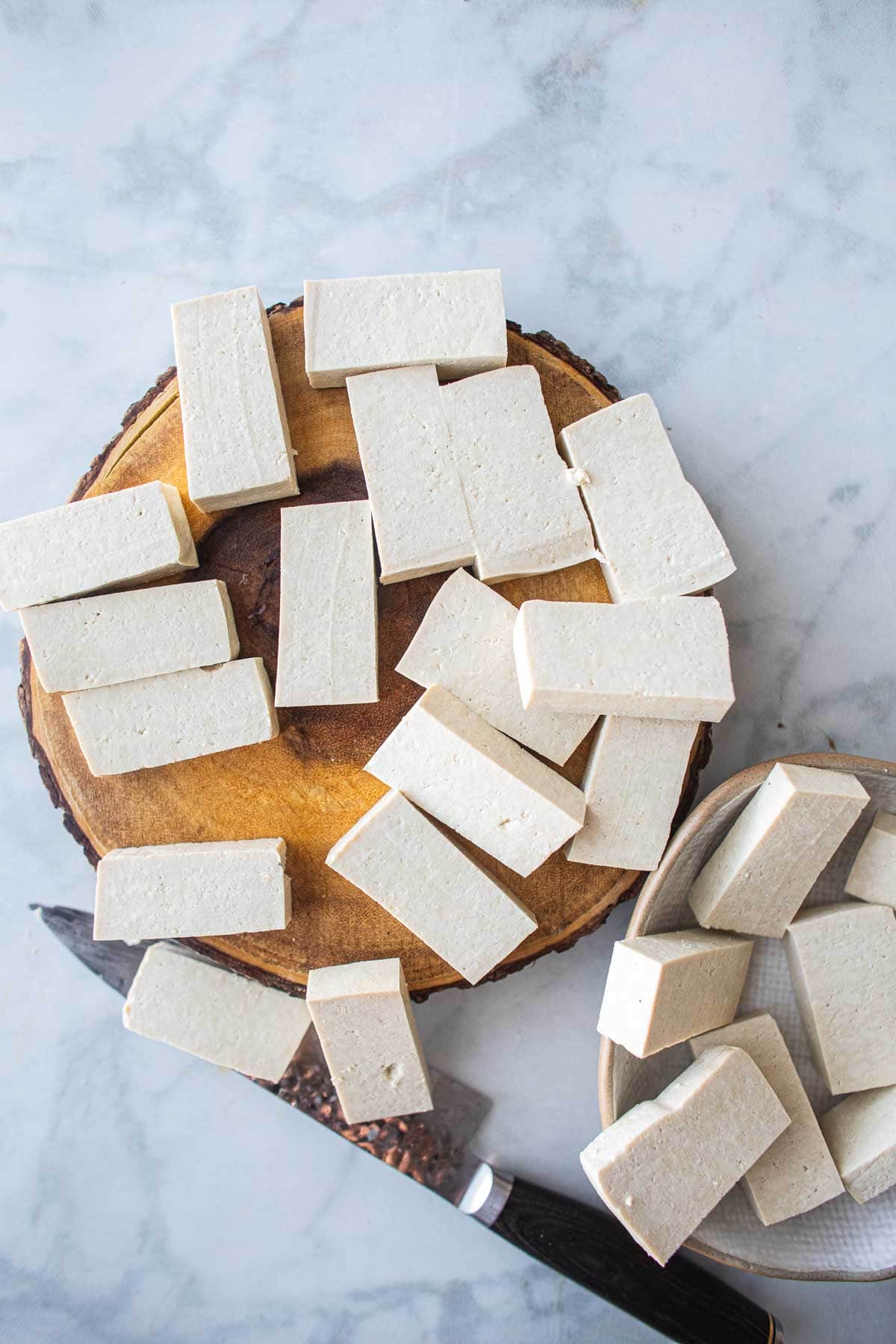 Tofu cubes on a cutting board.